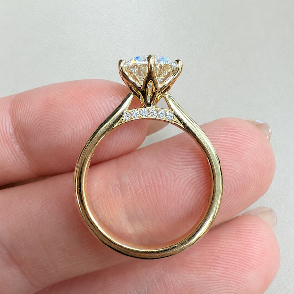 What Is a Cathedral Setting, and Who Is It Actually For? rb tulip yellow gold diamond bridge on hand.webp